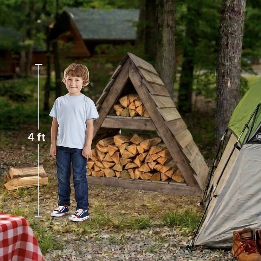 A child standing beside the four-foot Weekender firewood shed at a wooded campsite